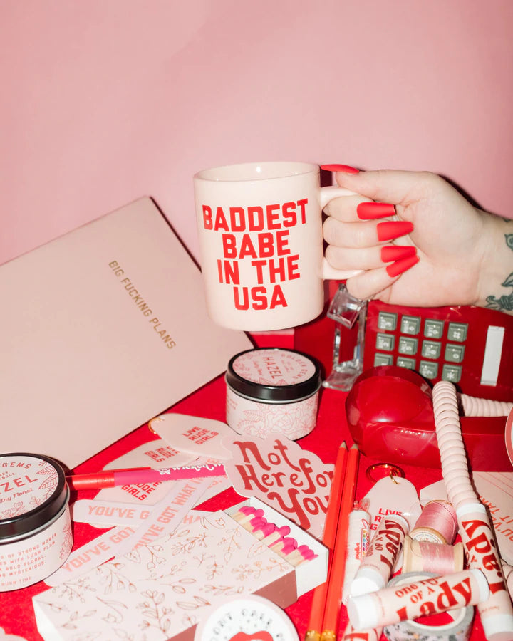 Golden Gems Tasse „Baddest Babe in the USA“.